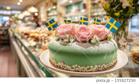 Swedish Princess cake decorated with roses in a bakery display Swedish Princess cake decorated with roses in a bakery display 135827250