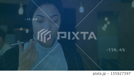 Issuing voice command using smartphone, woman standing in modern office with floating data and grid Issuing voice command using smartphone, woman standing in modern office with floating data and grid 135827397