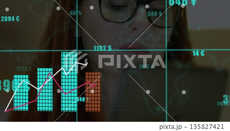 Analyzing woman wearing glasses and dark top holding smartphone at office desk, with chart overlays Analyzing woman wearing glasses and dark top holding smartphone at office desk, with chart overlays 135827421