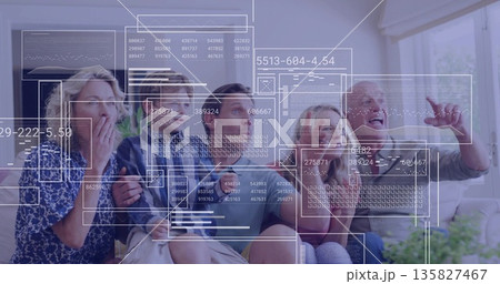 Reacting family of five watching floating data graphics on living room couch with plants and blinds 135827467