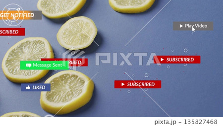 Displaying sliced yellow lemons arranged on textured blue tabletop, with social media UI alerts 135827468