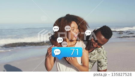 Lace-top woman hugging man in tropical shirt on shoreline, with ellipsis and bubble showing 71 135827528