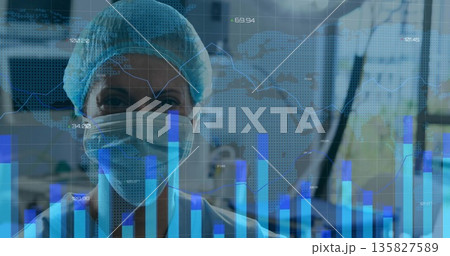 Monitoring nurse wearing cap and mask analyzing charts and graphs in clinic with world map overlay 135827589