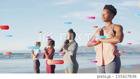 Meditating four women wearing activewear at beach edge, with search icons and ID tags floating 135827636