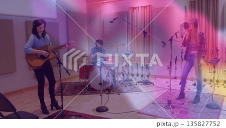 Recording three musicians strumming guitar, playing drums, singing in studio, with microphone gear 135827752