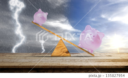 Two pink piggy banks on a wooden seesaw representing financial stability against a background of sunny skies and a brewing storm. Concept of economic balance and saving for a rainy day 135827954