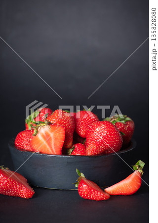Vibrant Fresh Strawberries In Bowl On Dark Background Vibrant Fresh Strawberries In Bowl On Dark Background 135828080