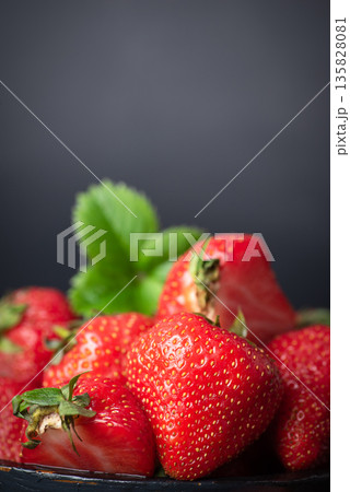 Vibrant Fresh Strawberries In Bowl On Dark Background Vibrant Fresh Strawberries In Bowl On Dark Background 135828081