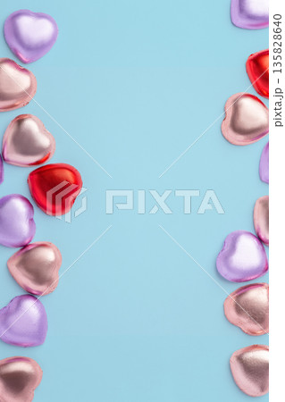 Valentines day and love background, Chocolate hearts with colorful foil wrapped on blue background, top view Valentines day and love background, Chocolate hearts with colorful foil wrapped on blue background, top view 135828640