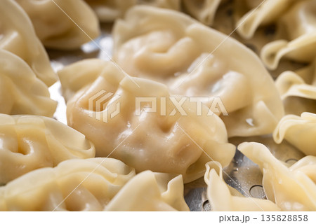 Close up of hot steamed dumplings in a steamer pot Close up of hot steamed dumplings in a steamer pot 135828858
