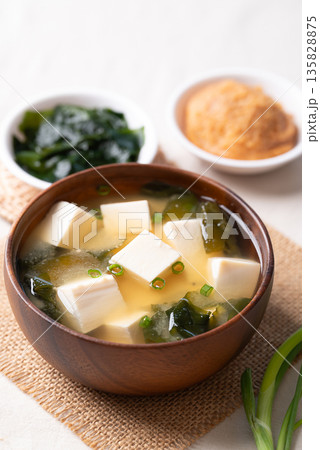Healthy Japanese miso soup with soft tofu and seaweed in a wooden bowl 135828875