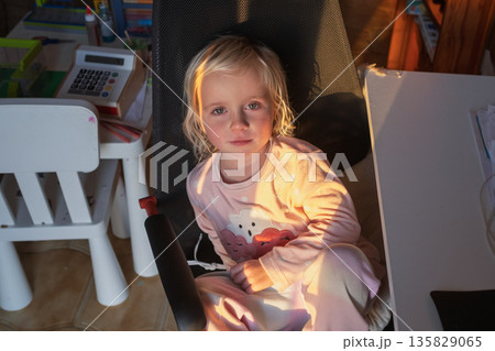 Bored 4-Year-Old Child Waiting in Big Computer Chair. Bored 4-Year-Old Child Waiting in Big Computer Chair. 135829065