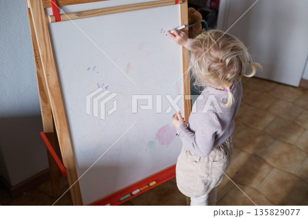 Smart preschool child pretending to be a teacher, early education and homeschooling concept. 135829077