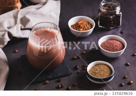Coffee with spices and cocoa powder in a glass on the table 135829610