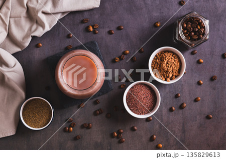 Spicy coffee with chocolate, salt and pepper in a glass on the table top view 135829613