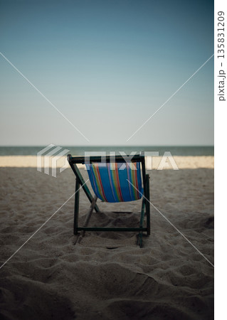 Lonely Beach Chair Facing the Calm Sea Lonely Beach Chair Facing the Calm Sea 135831209