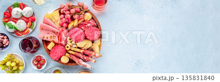 Italian Antipasti panorama. Charcuterie platter with cheese and other snacks Italian Antipasti panorama. Charcuterie platter with cheese and other snacks 135831840