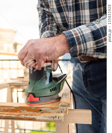 Carpenter at work, restoring an old wooden window. Carpentry. Carpenter at work, restoring an old wooden window. Carpentry. 135831928