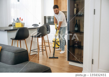 Male professional cleaning service worker is domestic room Male professional cleaning service worker is domestic room 135832431