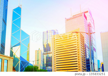 Skyscrapers tower in bright glass exteriors sunlight on sunset. Tower facade office buildings 135833251