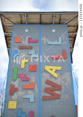 Colorful climbing wall against blue sky 135834489