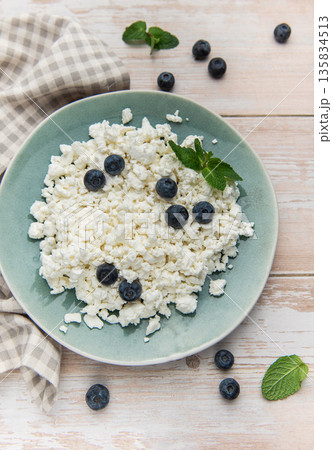 Cottage cheese with blueberries and mint on rustic table 135834513
