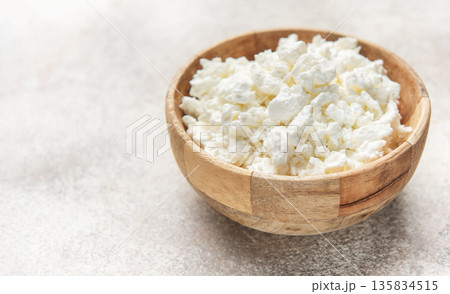 Cottage cheese in wooden bowl for healthy breakfast Cottage cheese in wooden bowl for healthy breakfast 135834515