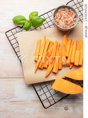 Preparing raw sweet potato fries for healthy cooking Preparing raw sweet potato fries for healthy cooking 135834526