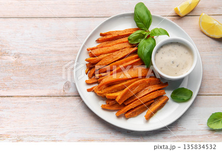 Sweet potato fries with dipping sauce and fresh basil Sweet potato fries with dipping sauce and fresh basil 135834532