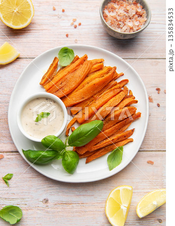 Sweet potato fries with dipping sauce and fresh basil Sweet potato fries with dipping sauce and fresh basil 135834533