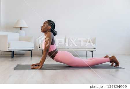 Spine exercise. Woman is doing yoga at home 135834609