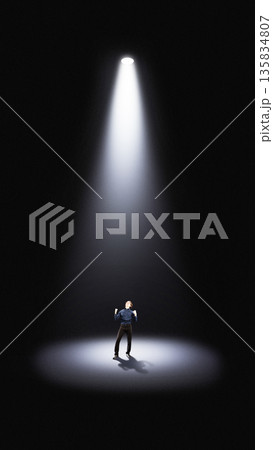 Dramatic poster with lone businessman under spotlight in empty space 135834807