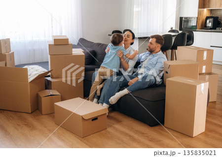 Finally some rest. Family of husband, wife and son are moving into new house Finally some rest. Family of husband, wife and son are moving into new house 135835021