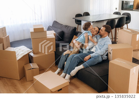Finally some rest. Family of husband, wife and son are moving into new house Finally some rest. Family of husband, wife and son are moving into new house 135835022
