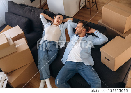 Wellness, lying down on sofa. Happy couple moved into new house 135835056