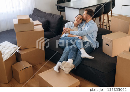 Black sofa, sitting and relaxing. Happy couple moved into new house 135835062