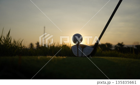 Golf clubs and balls on a green lawn in a beautiful golf course with morning sunshine. 135835661