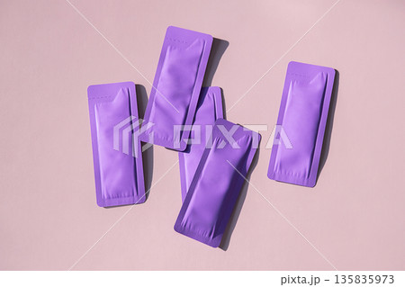 Several purple sachets displayed on light background with copy space. Several purple sachets displayed on light background with copy space. 135835973
