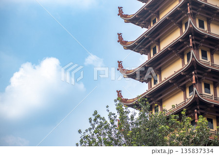 Tall building with a lot of red and brown decorations 135837334