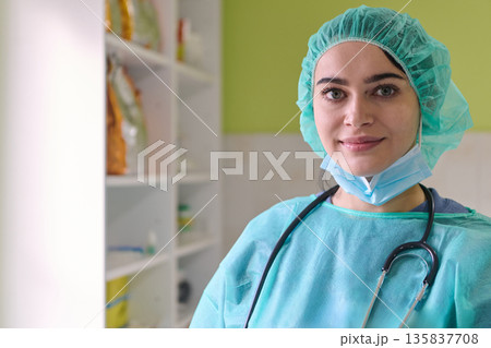 Smiling Female Healthcare Professional in Scrubs with Stethoscope in Modern Medical Setting 135837708