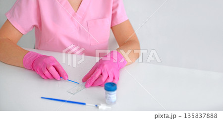 Laboratory technician in pink gloves preparing medical test sample on white table. Healthcare, diagnostics, analysis and clinical research concept with copy space. Laboratory technician in pink gloves preparing medical test sample on white table. Healthcare, diagnostics, analysis and clinical research concept with copy space. 135837888