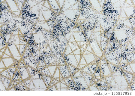 Off-white fabric with navy blue splatters and golden geometric lines Off-white fabric with navy blue splatters and golden geometric lines 135837958
