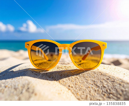 Travel lifestyle. Stylish yellow sunglasses on a sandy beach. Travel lifestyle. Stylish yellow sunglasses on a sandy beach. 135838835