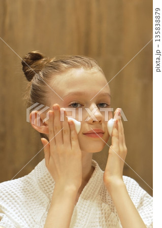 Cute Teen Girl Applies Cleansing Foam to Face in Front Mirror in Modern Bathroom. Blonde Caucasian Gen Alpha Girl Washing Face. Skincare routine for youthful, healthy skin. Beauty Routine. Cute Teen Girl Applies Cleansing Foam to Face in Front Mirror in Modern Bathroom. Blonde Caucasian Gen Alpha Girl Washing Face. Skincare routine for youthful, healthy skin. Beauty Routine. 135838879