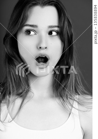 Young woman expressing surprise with wide eyes and open mouth 135838894