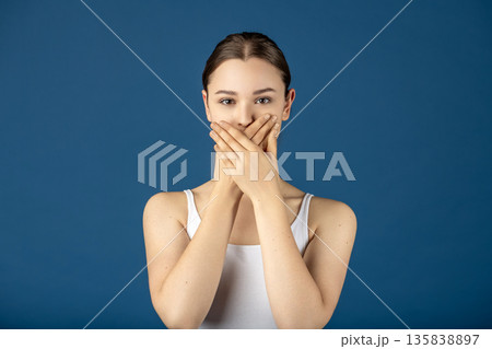 Woman covering mouth keeping secret or silence 135838897