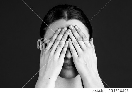 Woman hiding her face covering eyes with hands Woman hiding her face covering eyes with hands 135838898