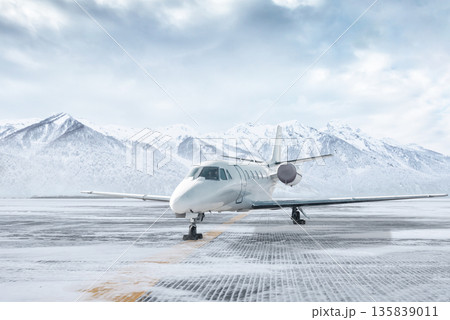 White private jet at winter airport on the background of high snow capped mountains White private jet at winter airport on the background of high snow capped mountains 135839011