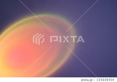 Abstract purple background showing soft glowing orange and pink light halo 135839354