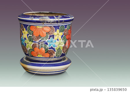 old and dirty blue and white ceramic pot on ceramic saucer, on gradient purple and green background, object, vintage, retro, ancient, copy space 135839650